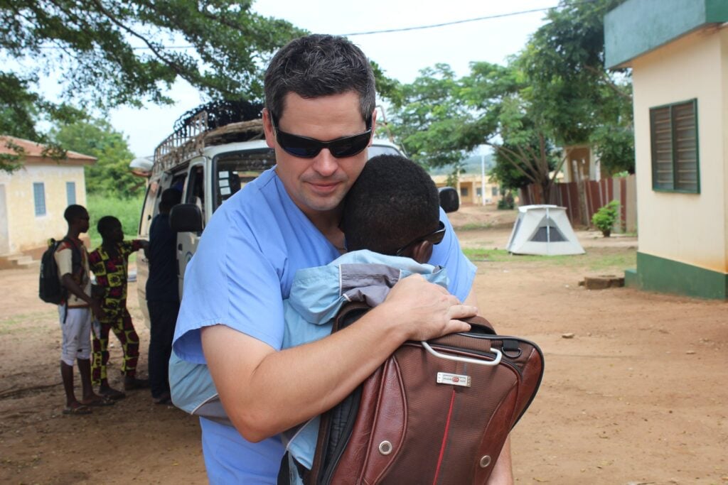Sight.org CEO embracing a patient during outreach