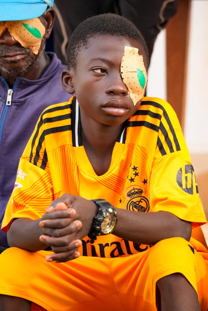 Boukari waiting after cataract surgery in rural Togo