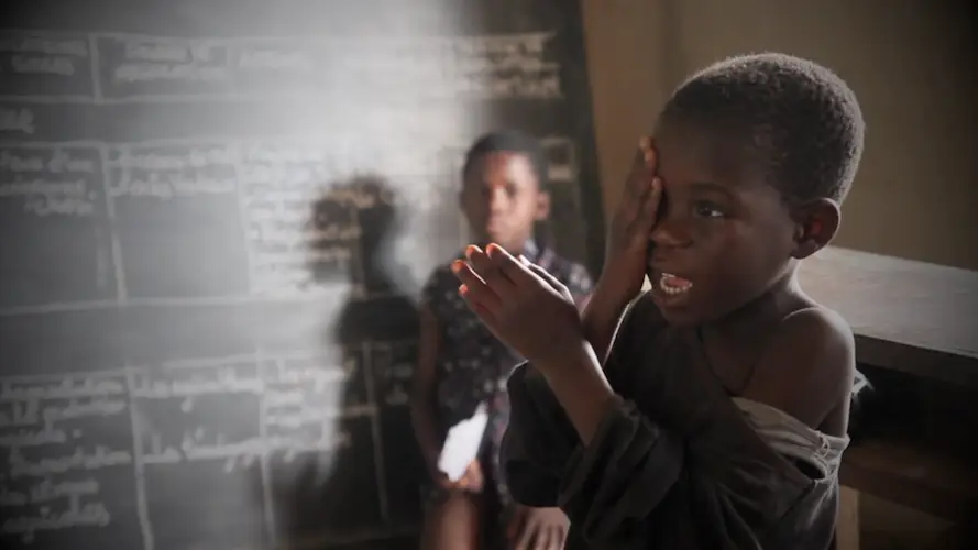 African boy reading eye chart after cataract surgery African boy reading eye chart after cataract surgery