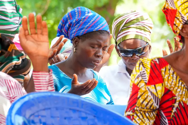 African women praying together after receiving cataract surgery African women praying together after receiving cataract surgery