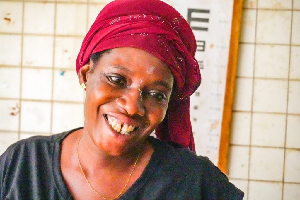 Odah Afi smiling after regaining clear vision through cataract surgery