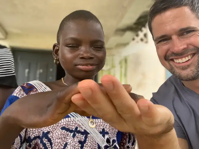 Lewis Swann with smiling African girl after cataract surgery