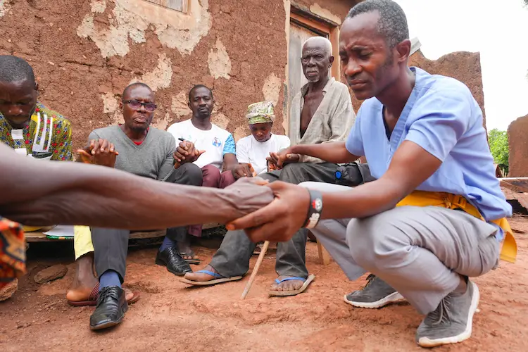 Sight.org team member praying with Africans Sight.org team member praying with Africans
